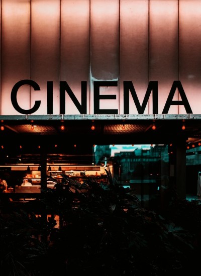 CINEMA sign above the entrance of a movie theater at night